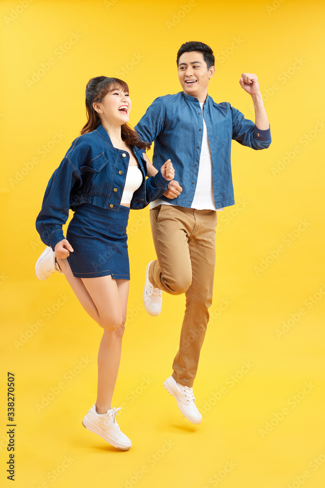 Full length body size view of nice attractive lovely cheerful cheery couple jumping up in air isolat