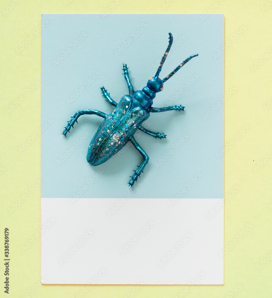Colorful miniature bug on a paper