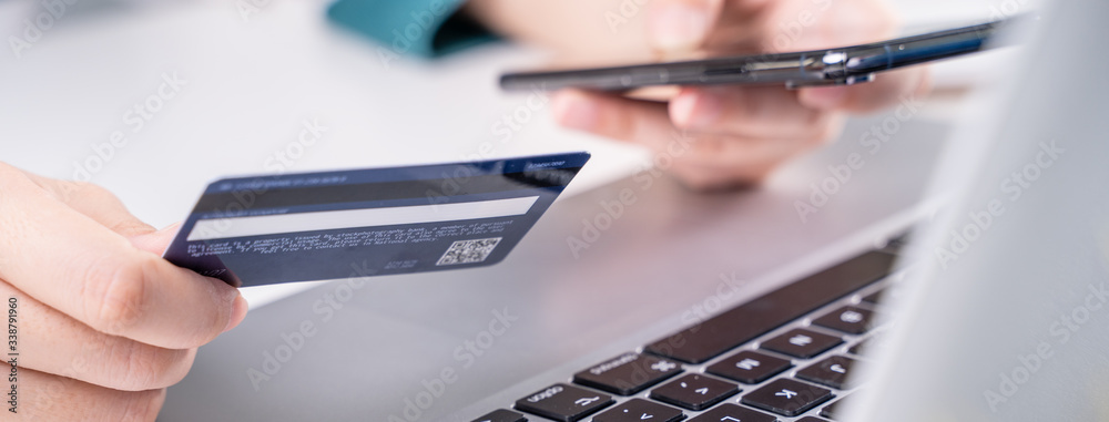 Online paying shopping, electronic payment with credit card, smart phone concept, laptop over white 