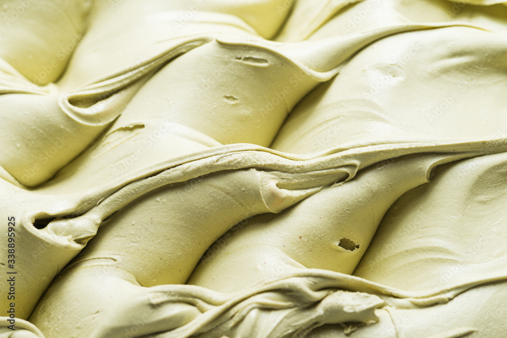 开心果口味冰淇淋-全框架细节。乳绿色开心果表面纹理特写