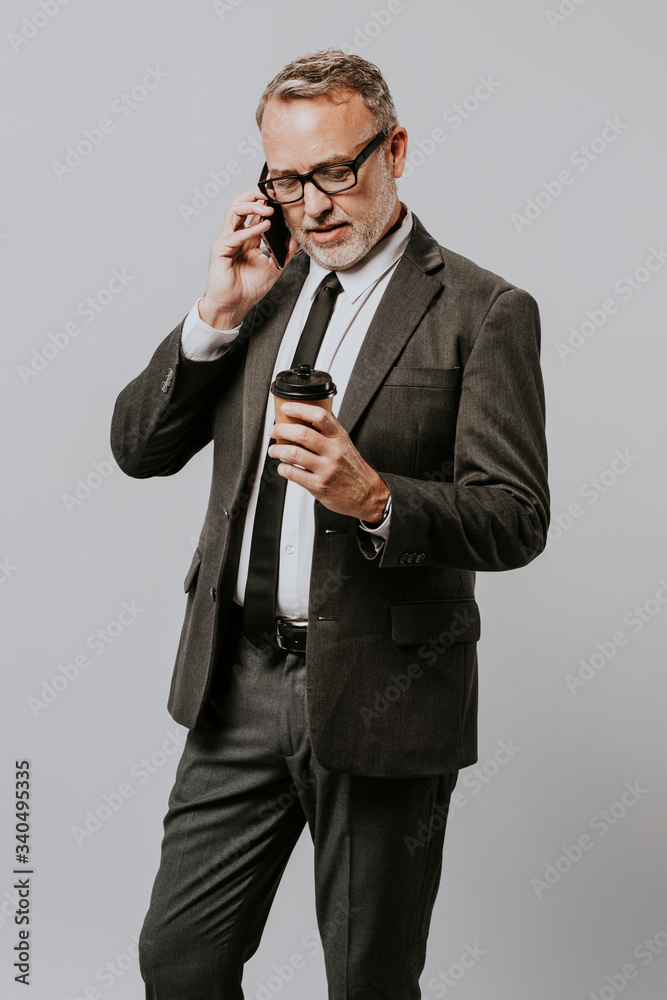 Businessman on the phone holding a coffee