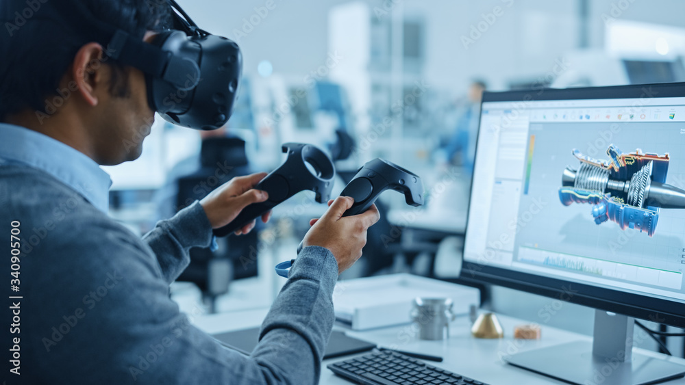 Modern Industrial Factory: Mechanical Engineer Wearing Virtual Reality Headset, Holding Controllers,