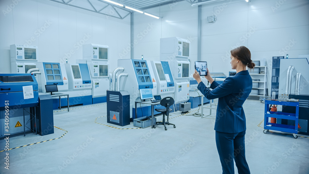 Modern Factory: Female Engineer Uses Digital Tablet Computer with Augmented Reality Software to Visu