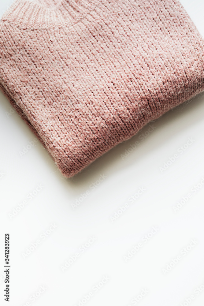 Flat lay of pink knitted sweater
