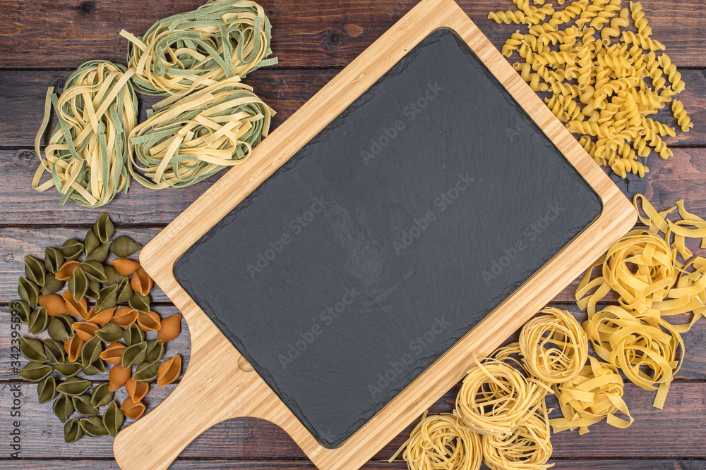 Dry pasta background. Pasta on dark background. Flat lay. Top view.