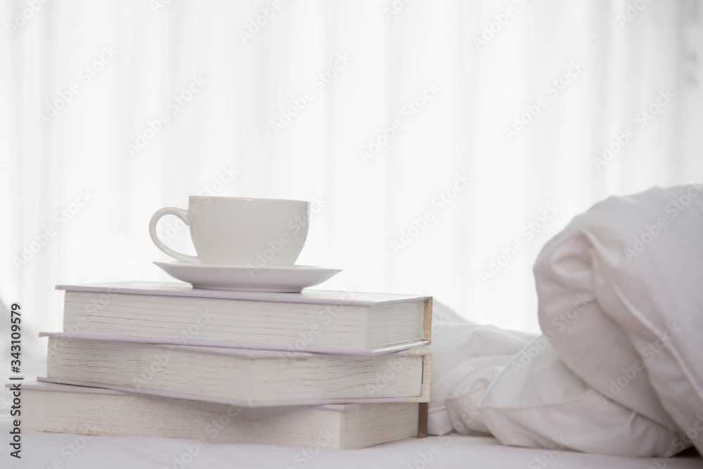 Close up on coffee cup on books   in bedroom at home