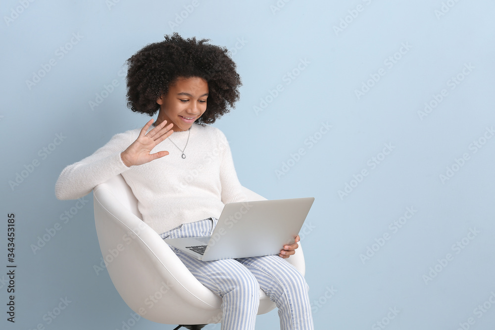 非裔美国青少年博主，彩色背景笔记本电脑