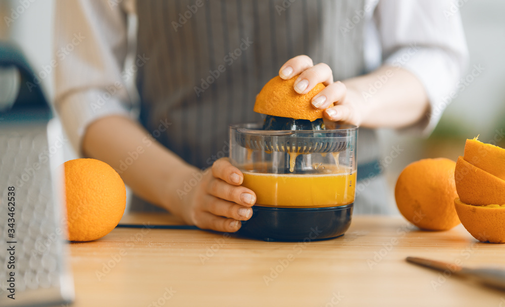 女人正在准备新鲜橙汁