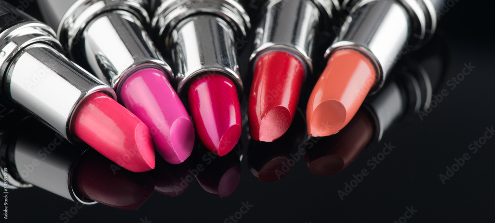 Lipstick. Fashion Colorful Lipsticks over black background. Lipstick tints palette, Professional Mak