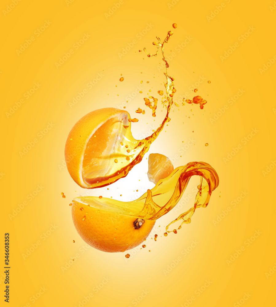 Juice splashes out from sliced orange on a yellow background