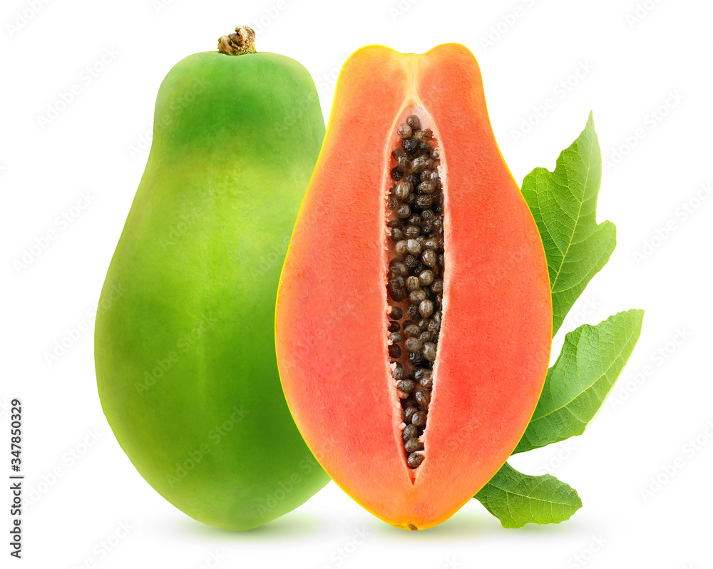Isolated halved papaya. One green papaya fruit and a half in vertical posiotion with leaf isolated o