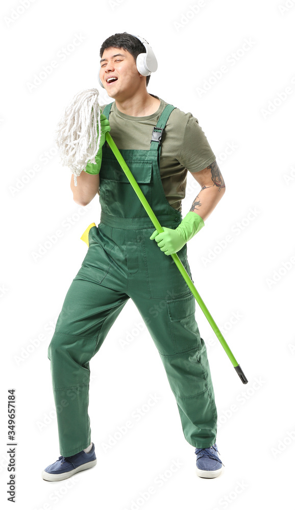 Male janitor with mop and headphones having fun on white background
