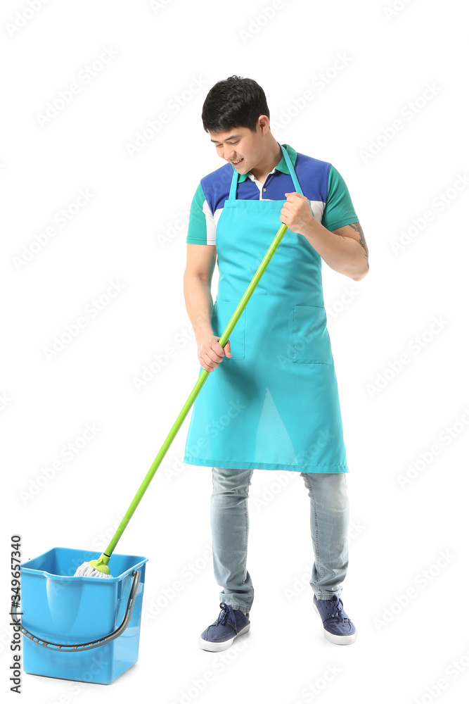 Young Asian man with mop and bucket on white background