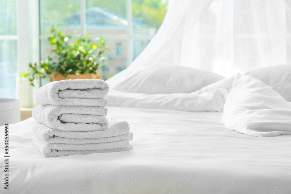 Clean towels on bed at home