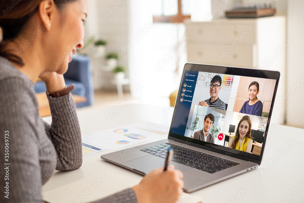 Young Asian businesswoman work at home and virtual video conference meeting with colleagues business