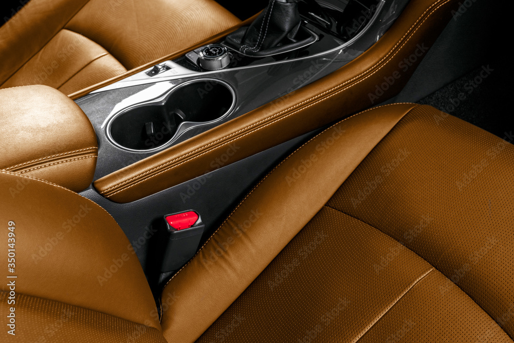 Brown leather interior of the luxury modern car. Perforated brown leather comfortable seats with sti