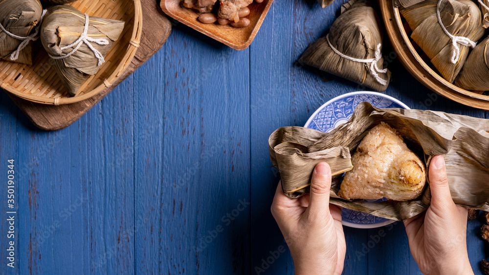 Rice dumpling, zongzi - Traditional Chinese food on blue wooden background of Dragon Boat Festival, 