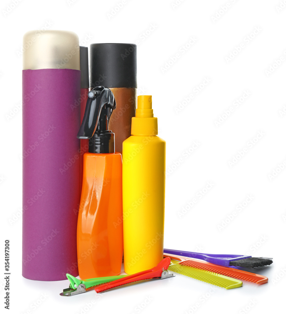 Hair sprays with hairdresser supplies on white background