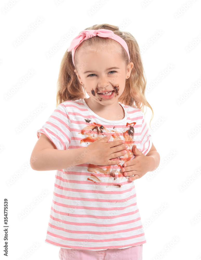 Little girl with chocolate stains on her clothes against white background