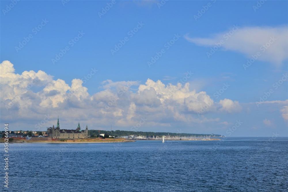 Denmark. Landscape in blue tones of the sky and water. The coast of Copenhagen is visible in the dis
