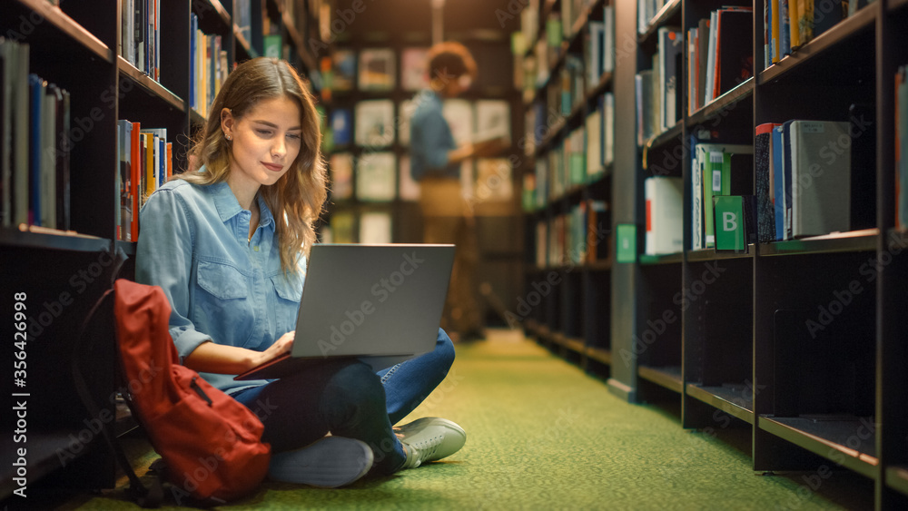 University Library: Gifted Beautiful Caucasian Girl Sitting On Floor, Uses Laptop, Writes Notes for 