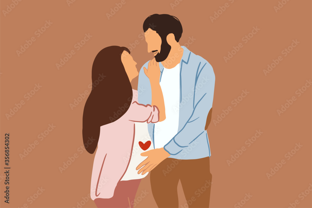 Portrait of a lovely couple hugging together on the background, man touching pregnant women belly.