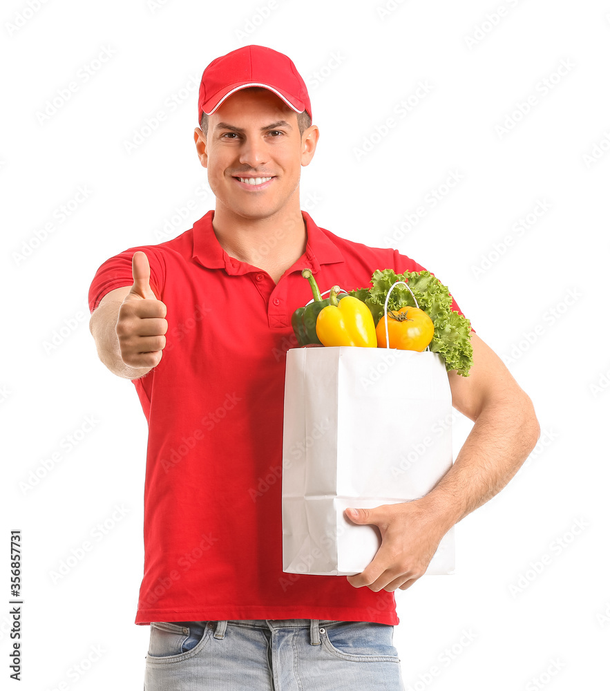 Delivery man with food in bag showing thumb-up gesture on white background