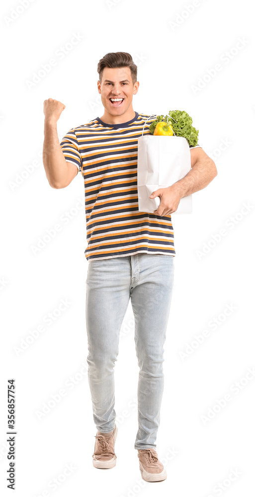 Happy man holding bag with food on white background