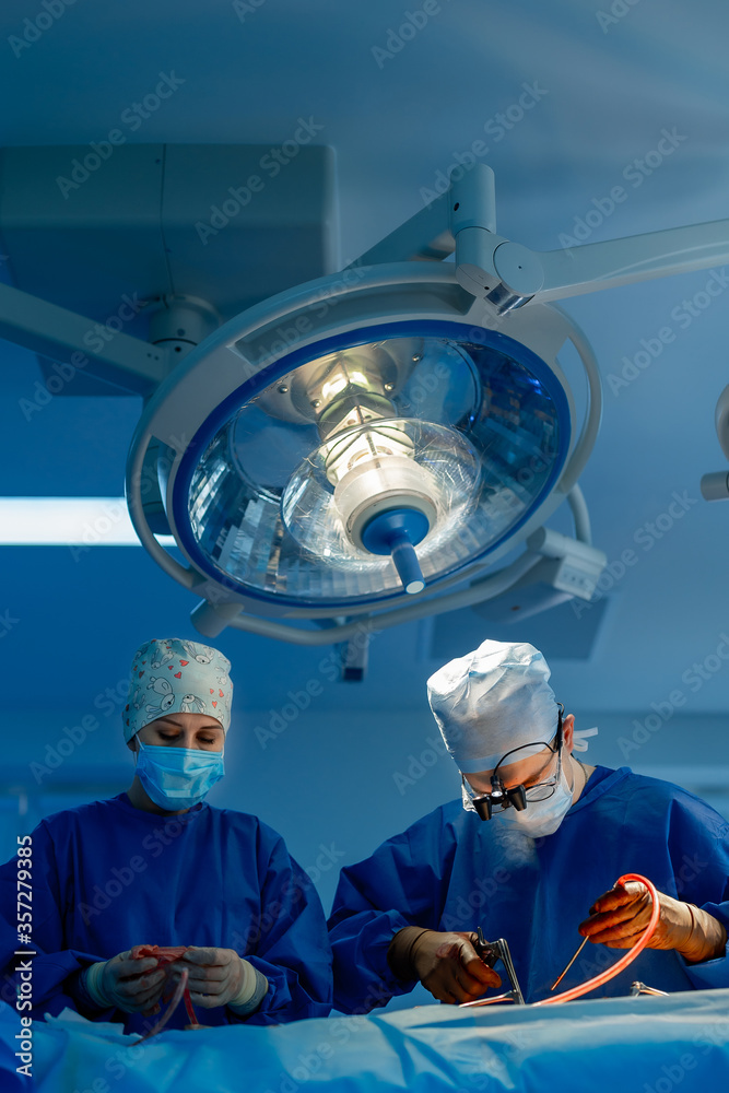 Surgeons working in operating room. Hospital background. Two male doctors at work. Circular backgrou