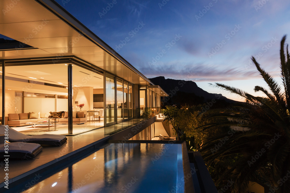 Modern house overlooking mountains at dusk