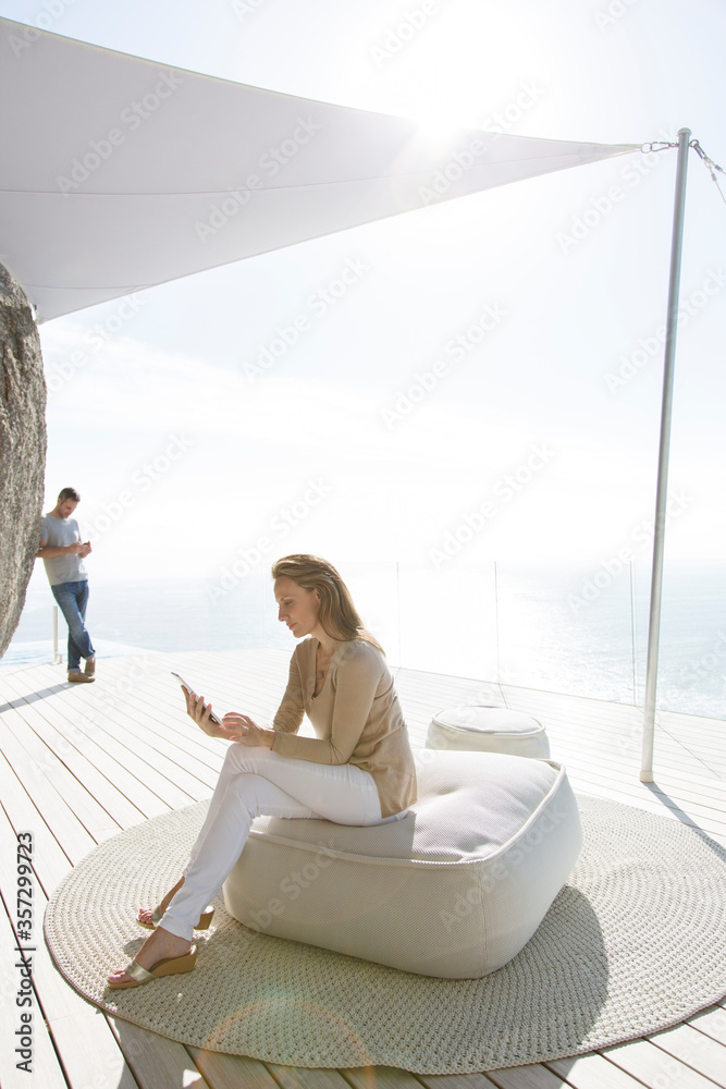 Woman using digital tablet on modern balcony