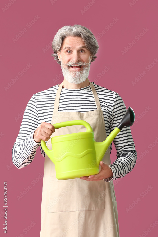 Senior gardener on color background