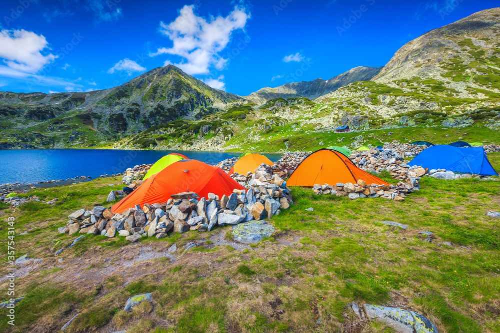 Wild camping place with colorful tents in the mountains, Romania