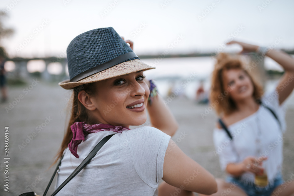 Close-up image of a beautiful girl with a hat enjoying the summer.