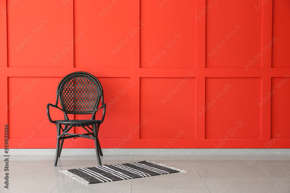 Chair with carpet near color wall in room