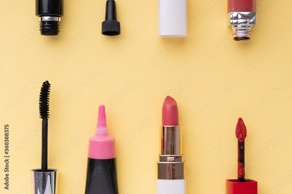 俯视图。平面布置。亮黄色背景上的化妆品化妆工具集。