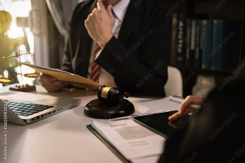 商界人士和律师坐在桌子旁讨论合同文件。法律概念，建议