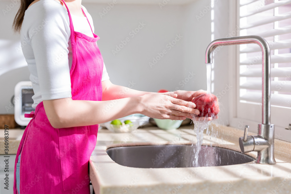 Asian housewife wash fruit