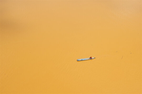 a lone boatman on the yellow river in Kota Bharu in Malaysia