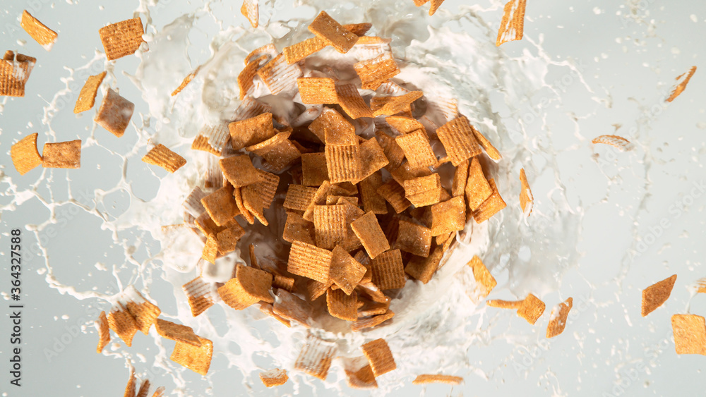 Freeze motion of rotating cereal pieces with milk splash