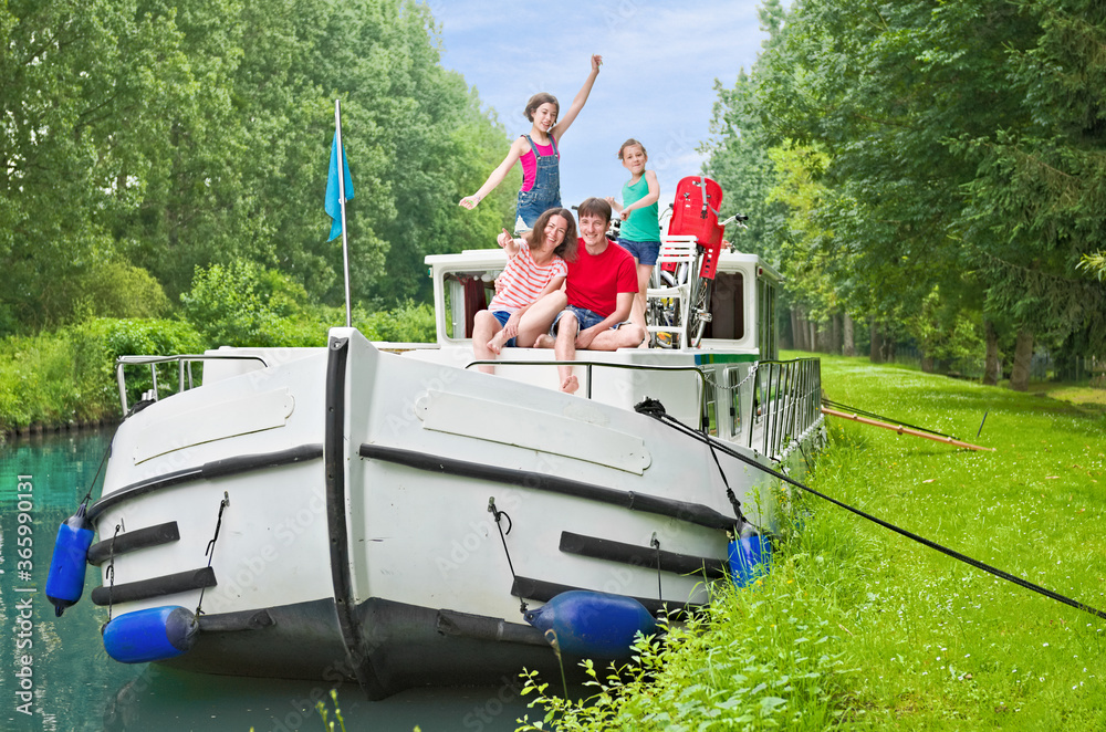 Family vacation, summer holiday travel on barge boat in canal, happy kids and parents having fun on 