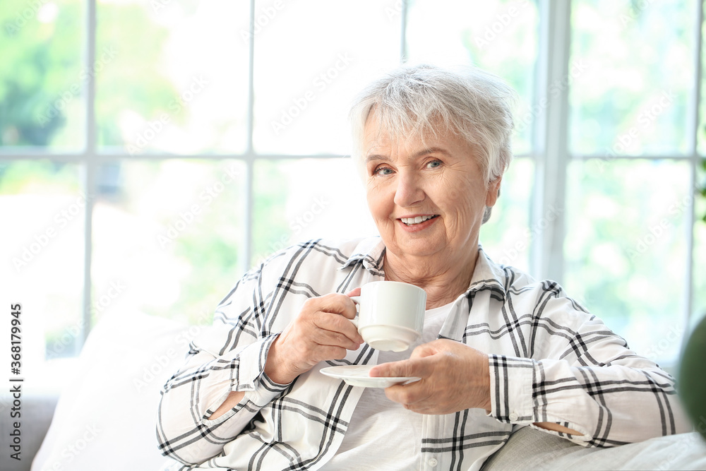 Senior woman drinking tea at home