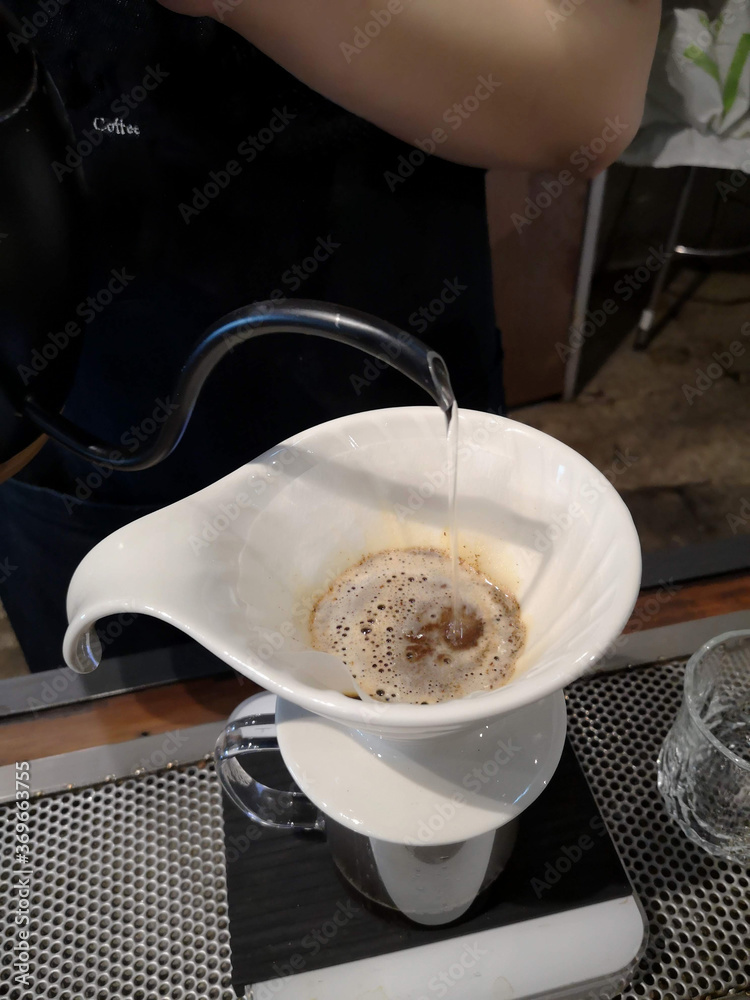 A cup for dripping coffee with hot water.