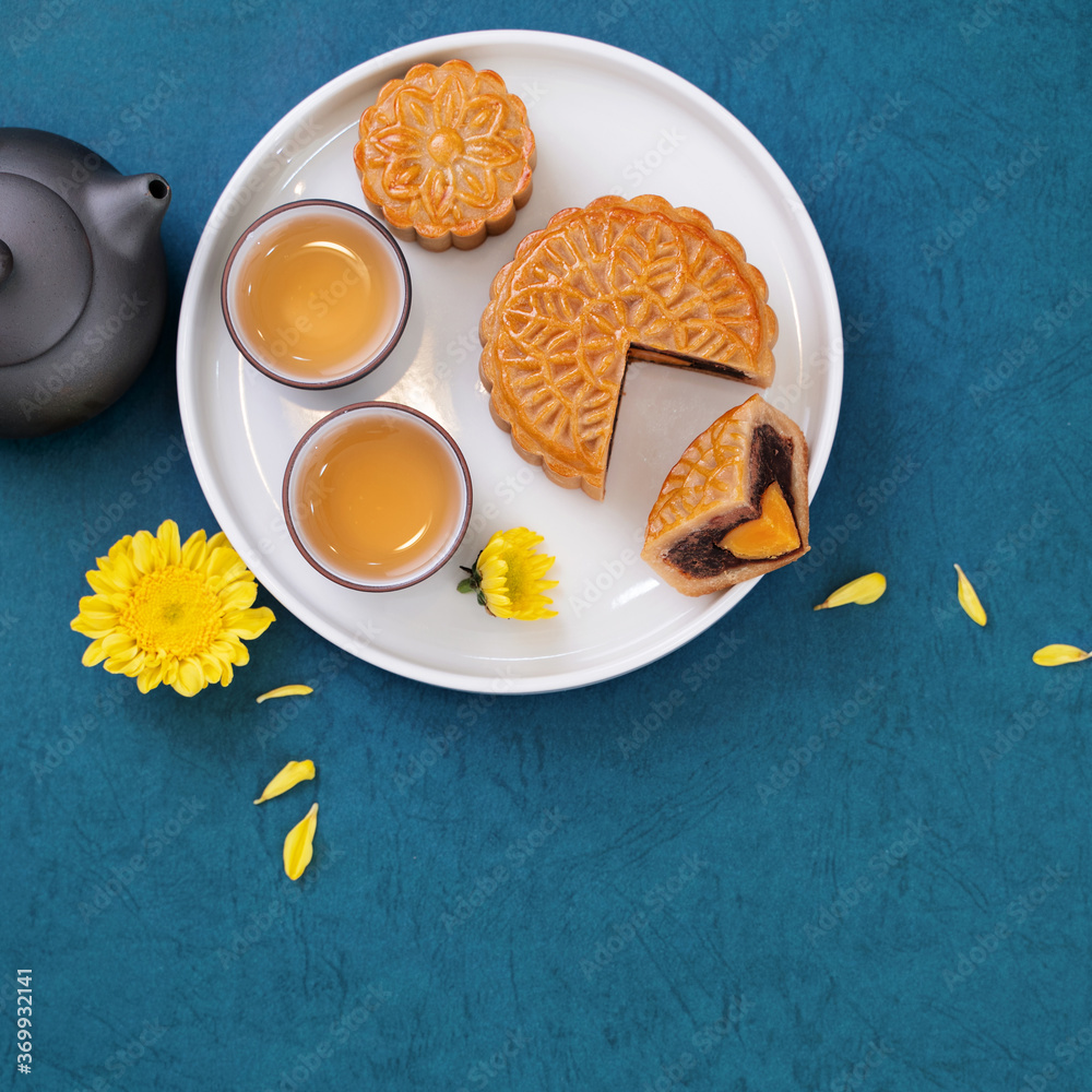 Minimal simplicity layout moon cakes on blue background for Mid-Autumn Festival, creative food desig