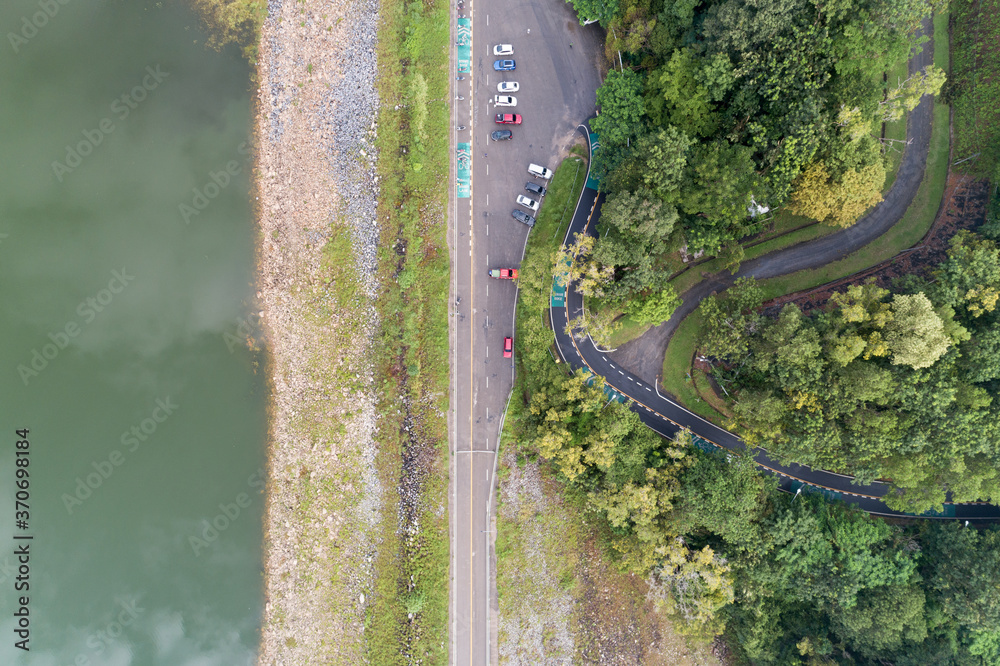 Aerial view top down photo from flying drone of asphalt road with cars and bicycle lane curve road a
