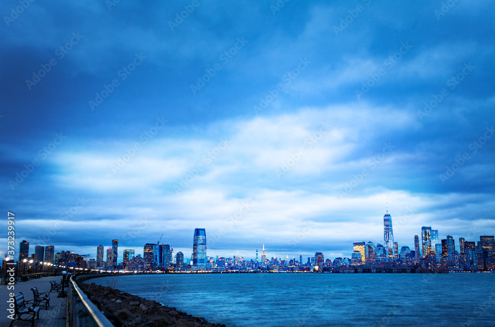 Dramatic panorama of New York Manhattan downtown from Jersey City over Hudson harbor