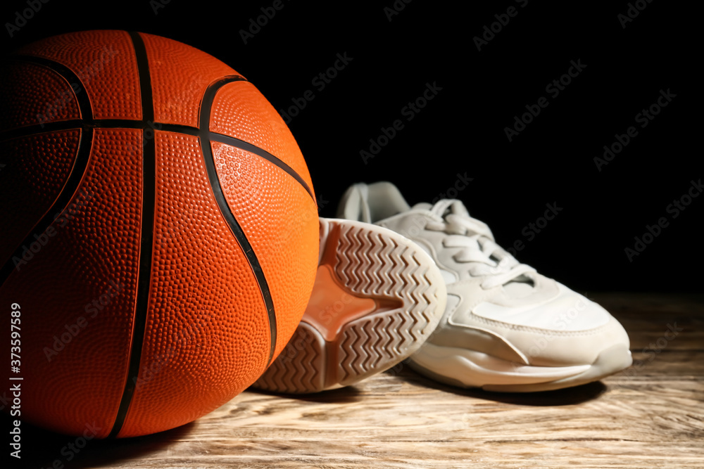 打篮球的球和桌子上深色背景下的鞋子