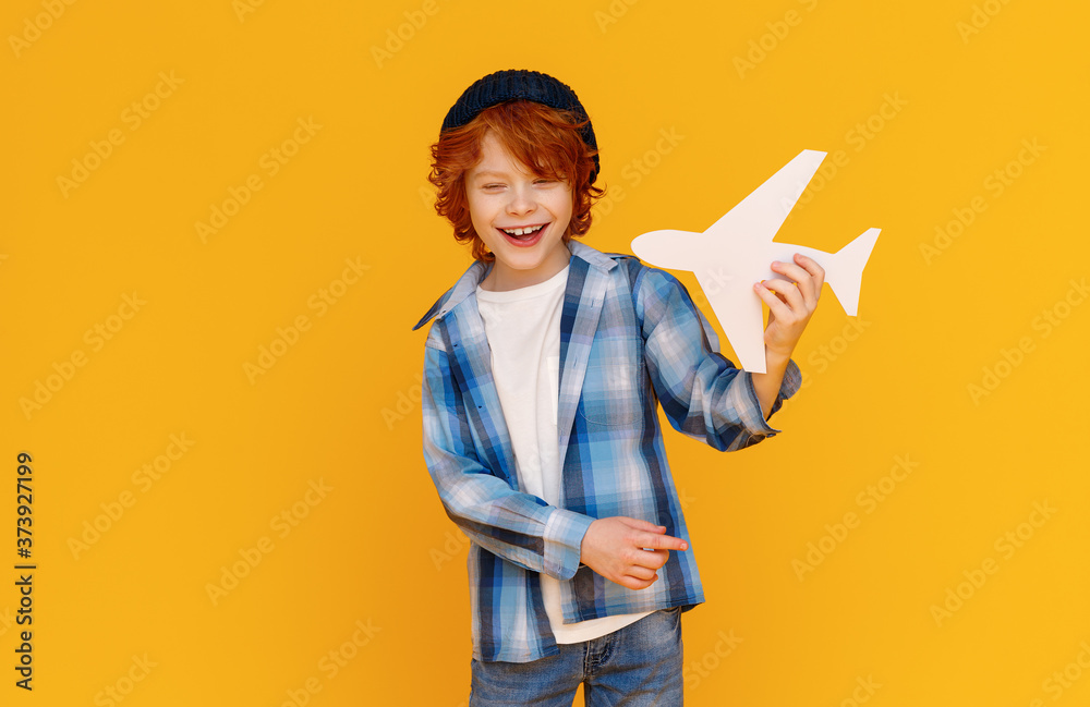 Stylish boy playing with toy plane.
