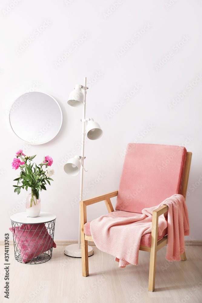 Stylish interior of room with mirror, table and armchair
