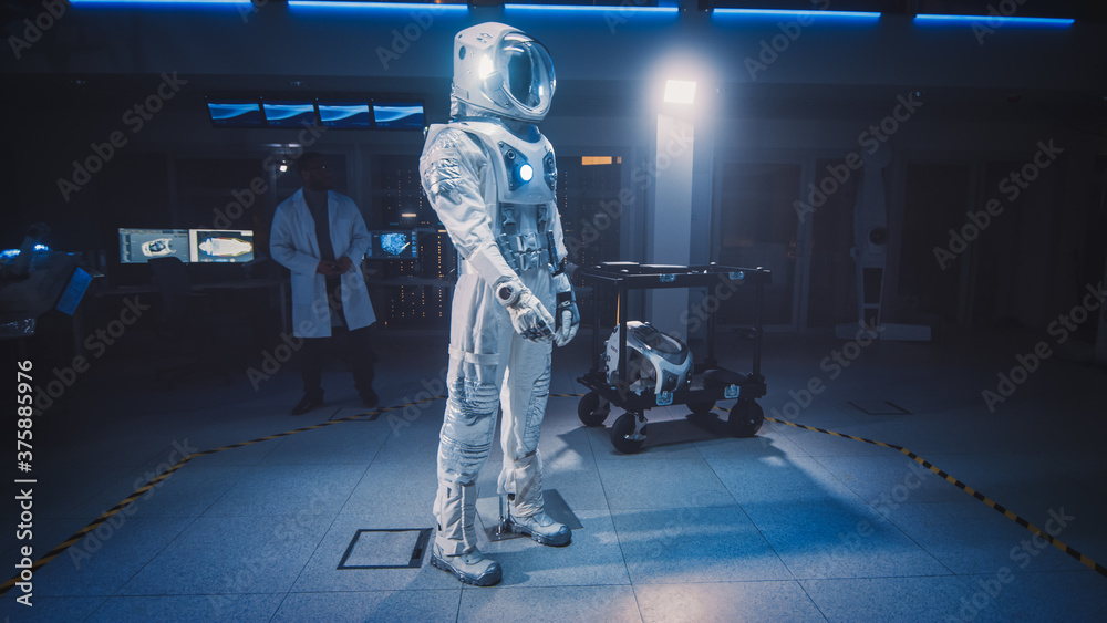 Low Angle Shot of an Astronaut Space Suit Adapted for Space and Travel Exploration Standing in an Ae